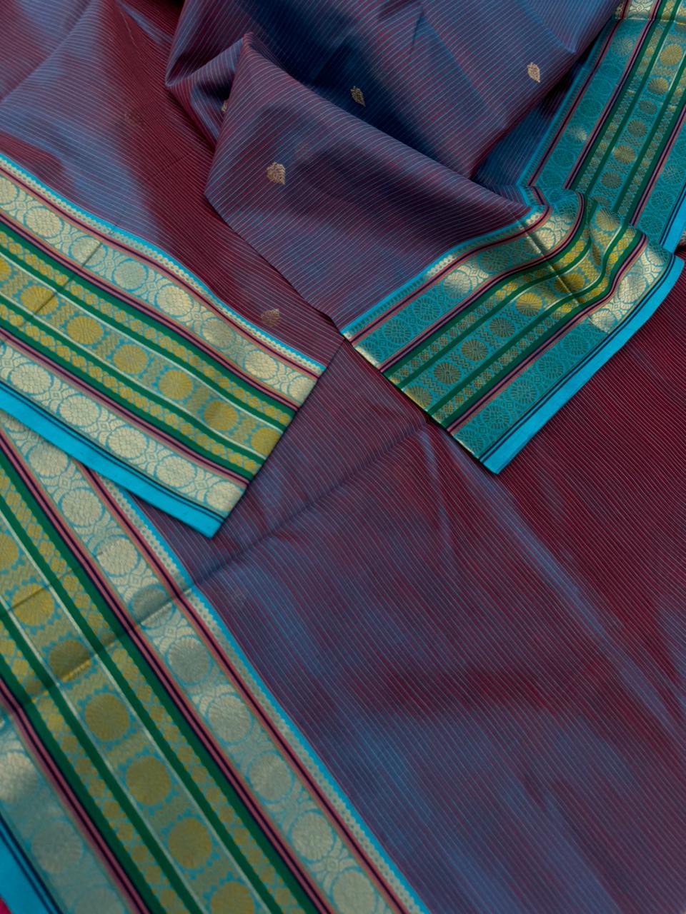 Zari Kissed Silk Cotton - a deep red short blue with laddu Kamalam motifs woven borders