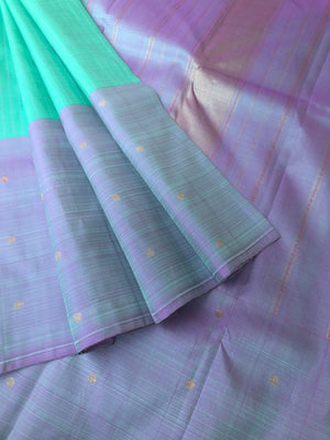 Radha Ragasiyam - Uniquely Woven Kanchivarams - a beautiful kind of sea green/pista green with broad lavender buttas woven borders