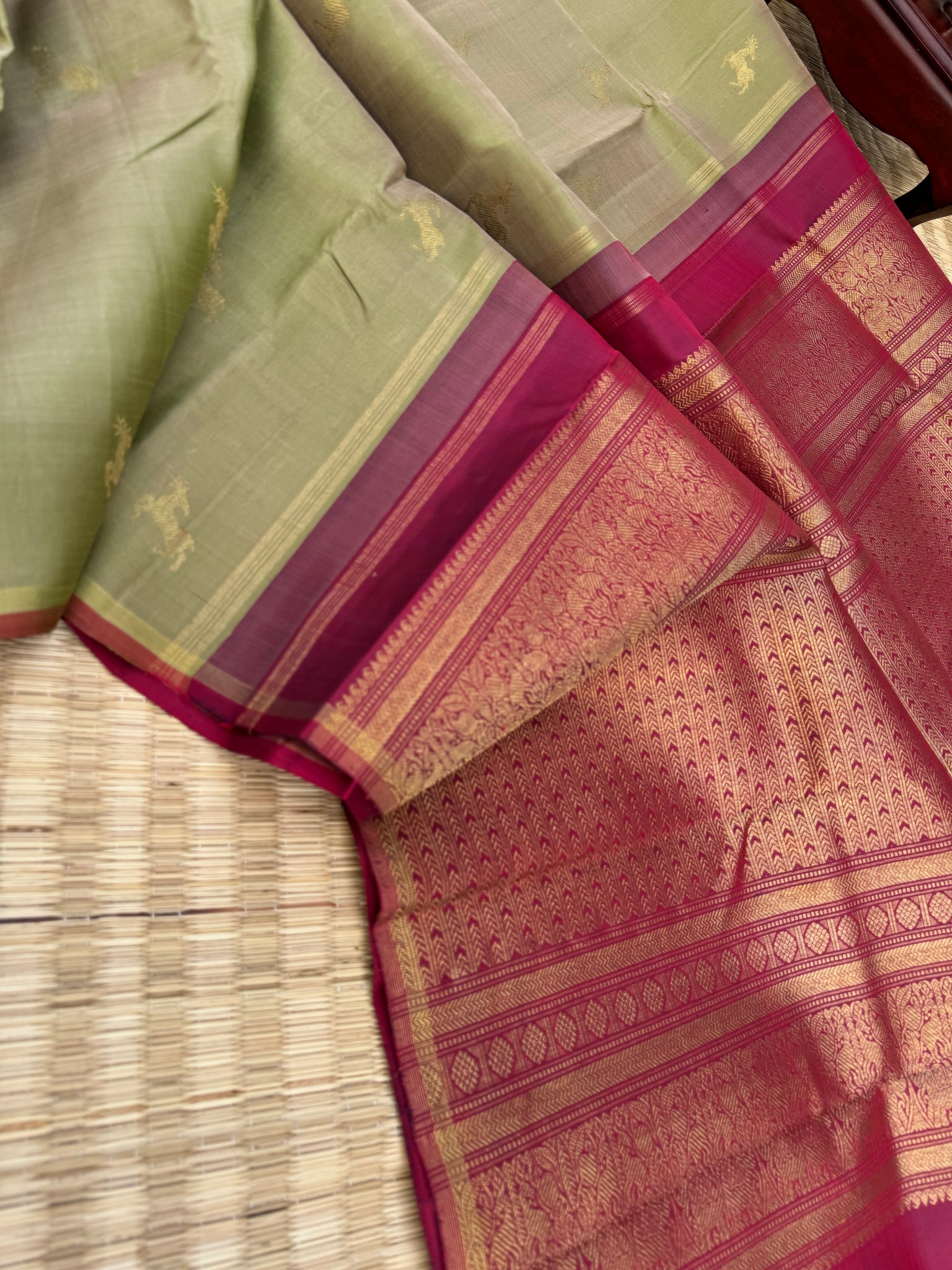 Corporate Kanchivarams - a pale elachi green and maroon borderless Kanchivaram with maan ( deer ) woven buttas