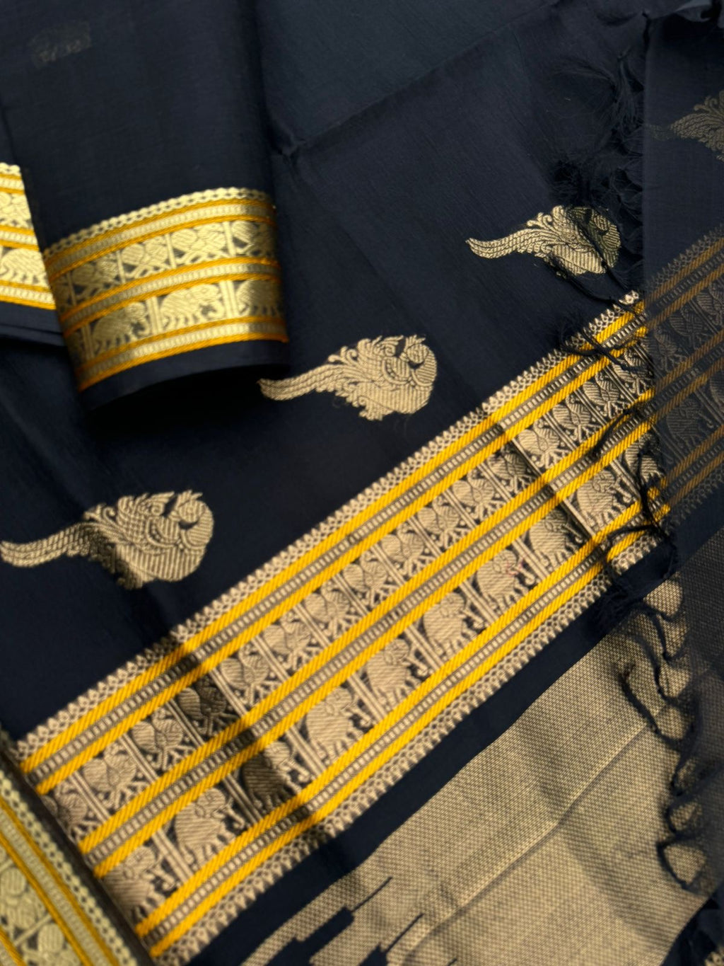 Black Edition of Zari Kissed Silk Cotton - full black and gold with konjum killi woven buttas inbetween the body and pallu