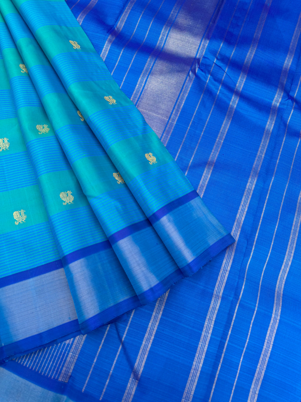 Album Untouched - a gorgeous teal and ananda blue body with mayil chackaram woven buttas