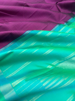 Shree - Simple and Elegant Kanchivarams - a stunning deep purple vertical muthu strips body with a dual tone turquoise blue pallu and blouse