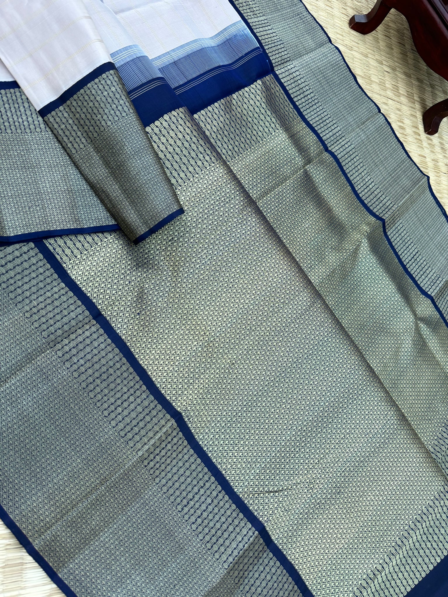 Pastel Kanchivarams - a chalk white absolutely no zari Korvai Kanchivaram with navy blue pallu and blouse