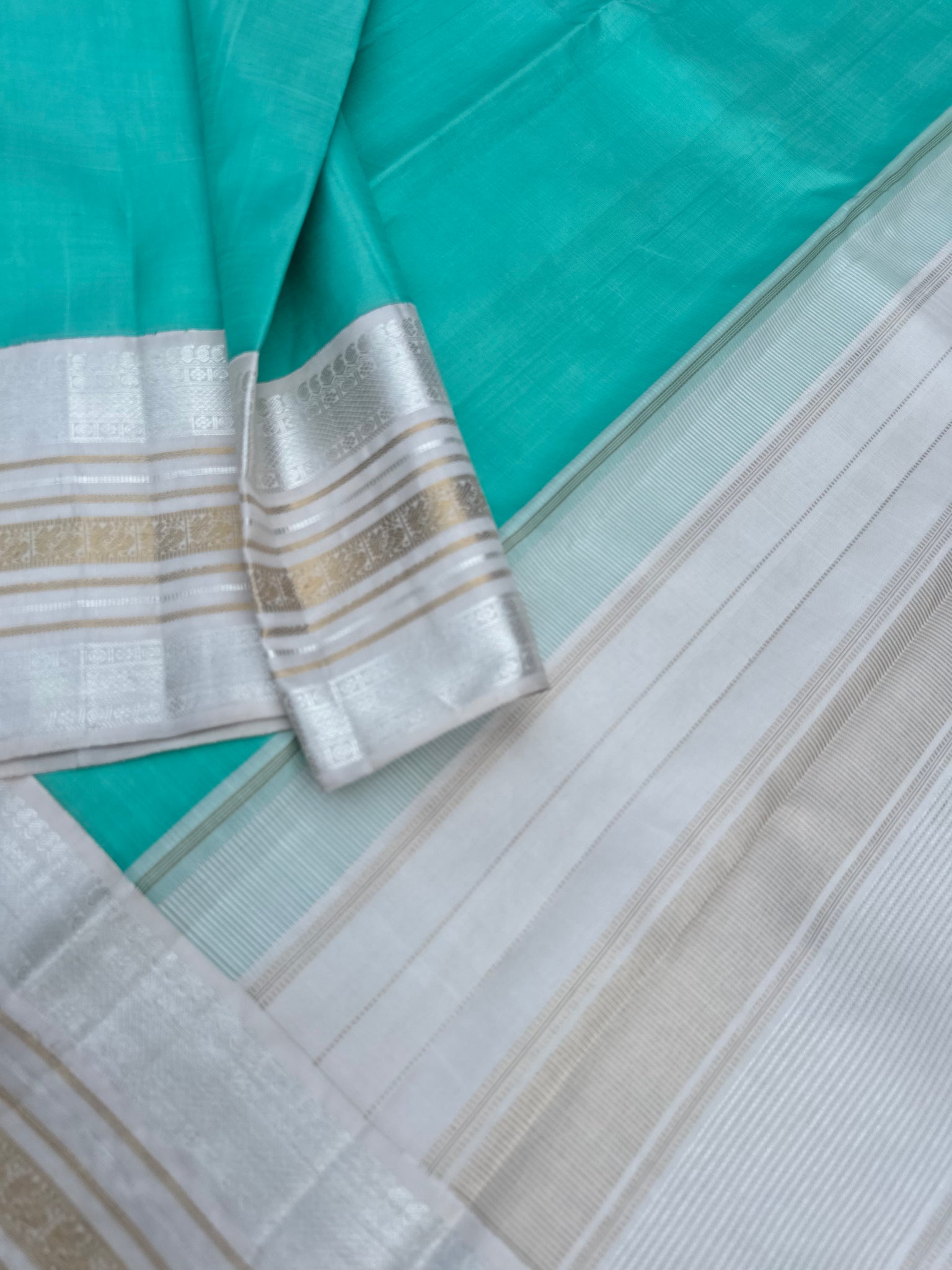 Diwali Edits - Soulful Kanchivaram - A pastel aqua green with silver and gold Zari Korvai ivory korvai borders