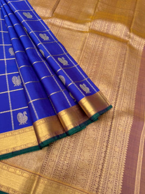 Colours of Navarathri 2025 on Kanchivarams - the traditional blue Mayil chackaram woven inside the veldhari kattam with intricate woven pallu
