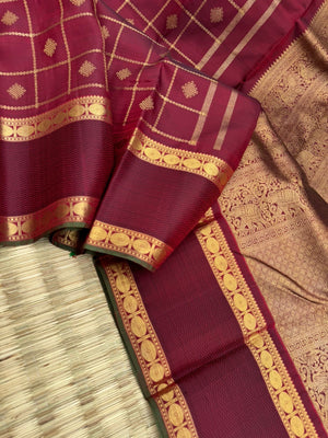 Annapoorani - the gorgeous deep maroon and gold with veldhari kolam buttas woven body with retta pett woven borders