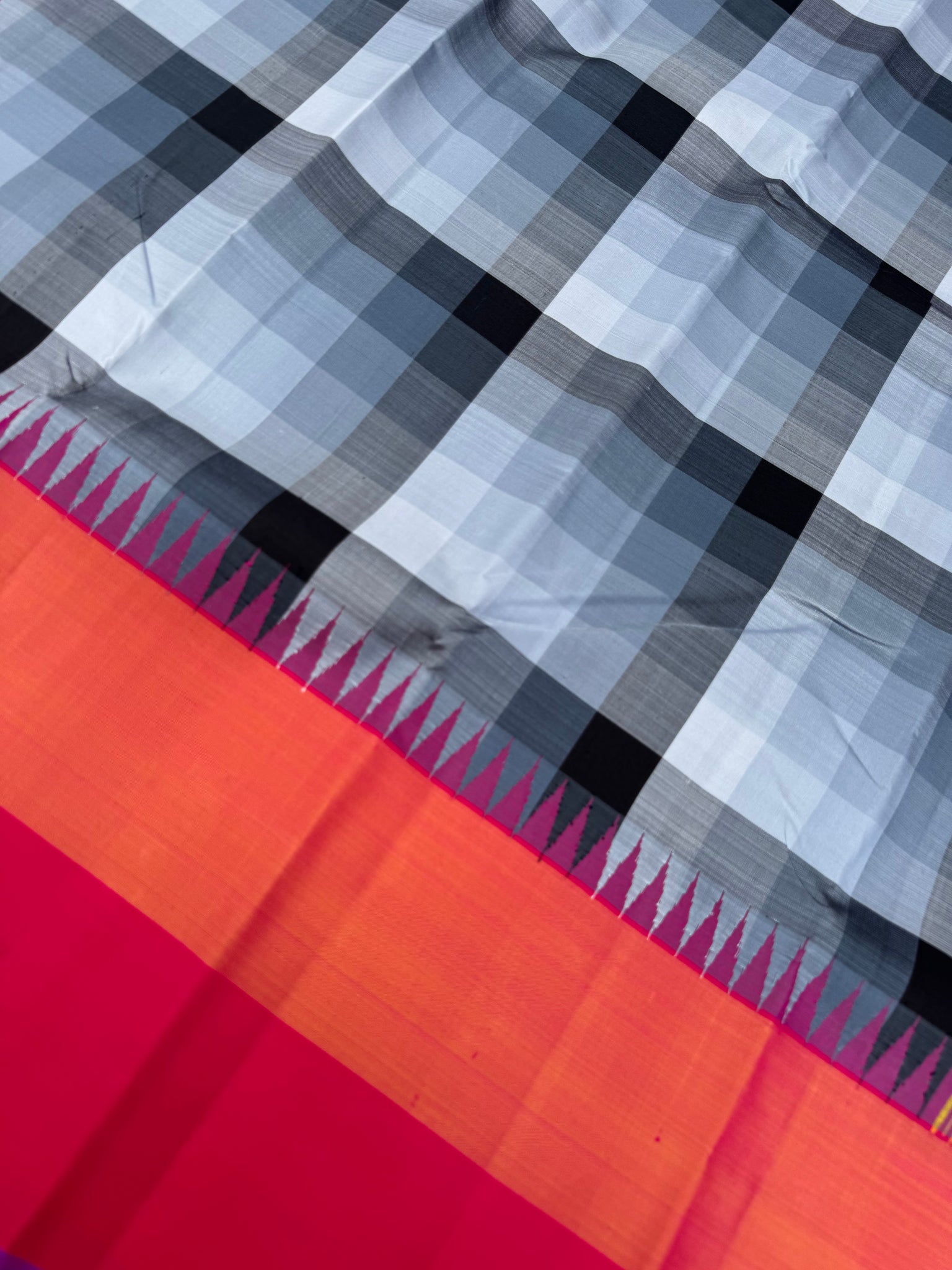One of the most difficult Kanchivaram Silk - the weaver has to handle seven shuttles ( 5 for body and 2 for the borders ) digital grey black off white chex with three colour band woven borders