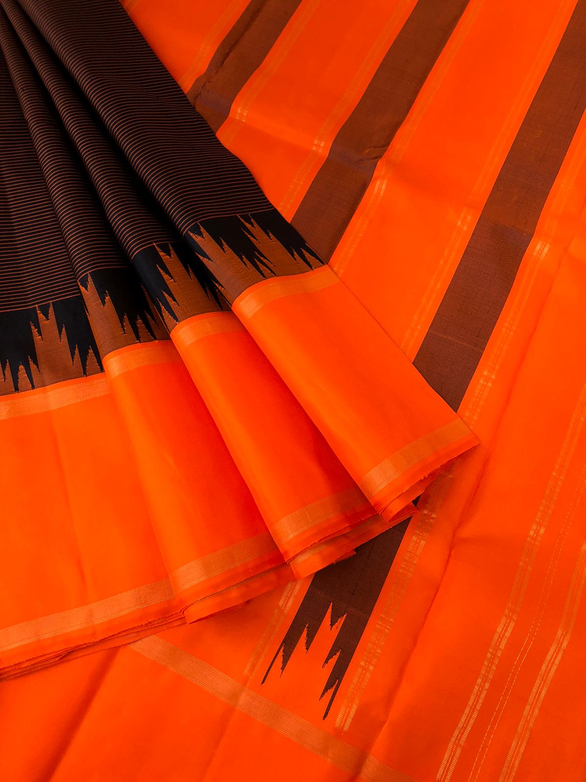 Connected by Korvai on Kanchivaram - a beautiful black stripes body with orange and pink ganga jammuna woven borders