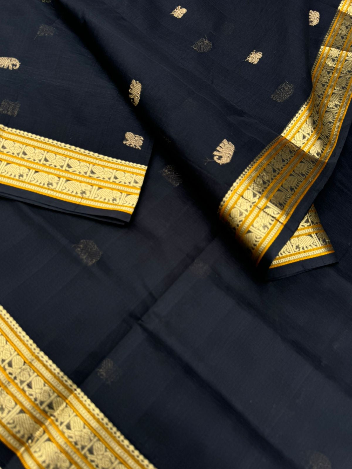 Black Edition of Zari Kissed Silk Cotton - full black and gold with konjum killi woven buttas inbetween the body and pallu
