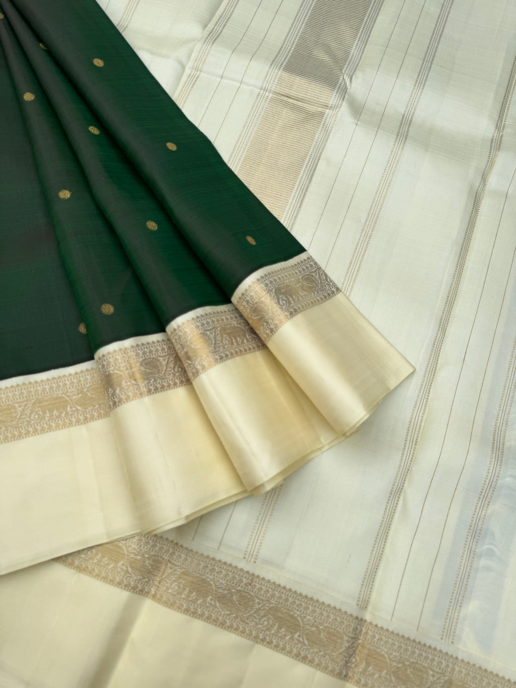 “Iyarkai” (இயற்கை) - Kanchivaram Colours Inspired from Mother Nature - a stunning deep dark bottle green and off white Korvai kanchivaram with kall erangina borders