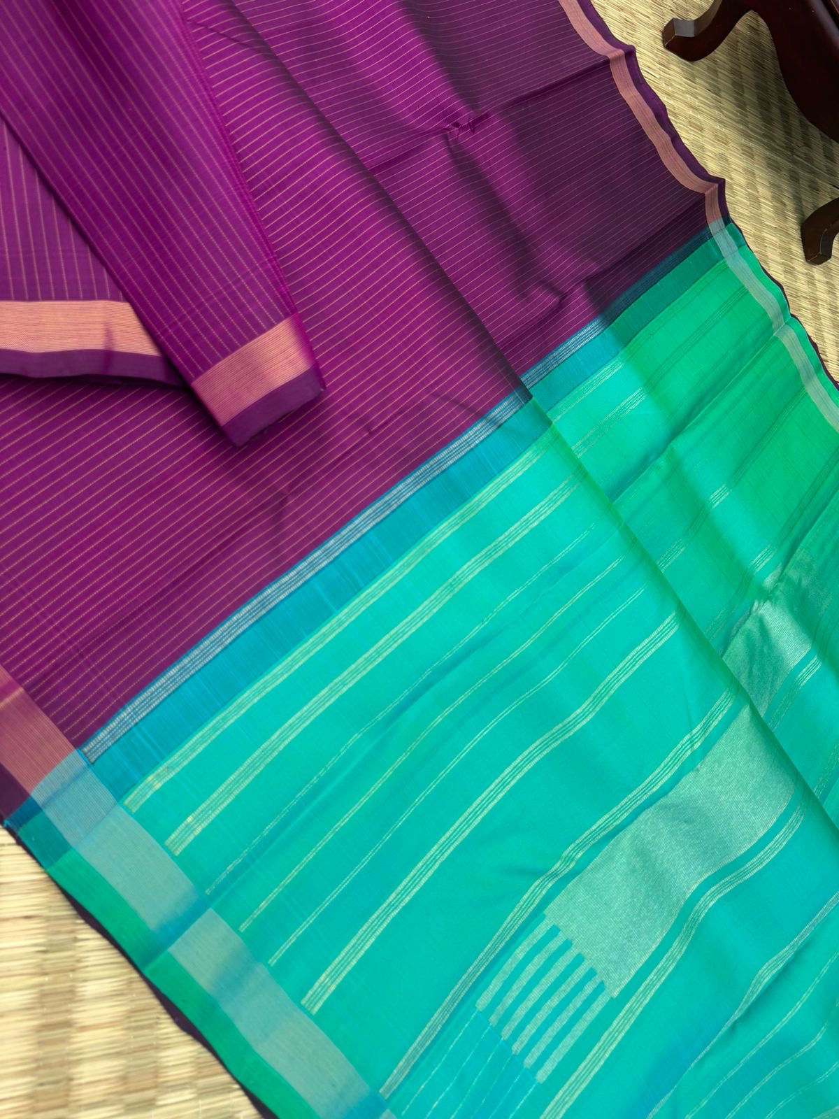 Shree - Simple and Elegant Kanchivarams - a stunning deep purple vertical muthu strips body with a dual tone turquoise blue pallu and blouse
