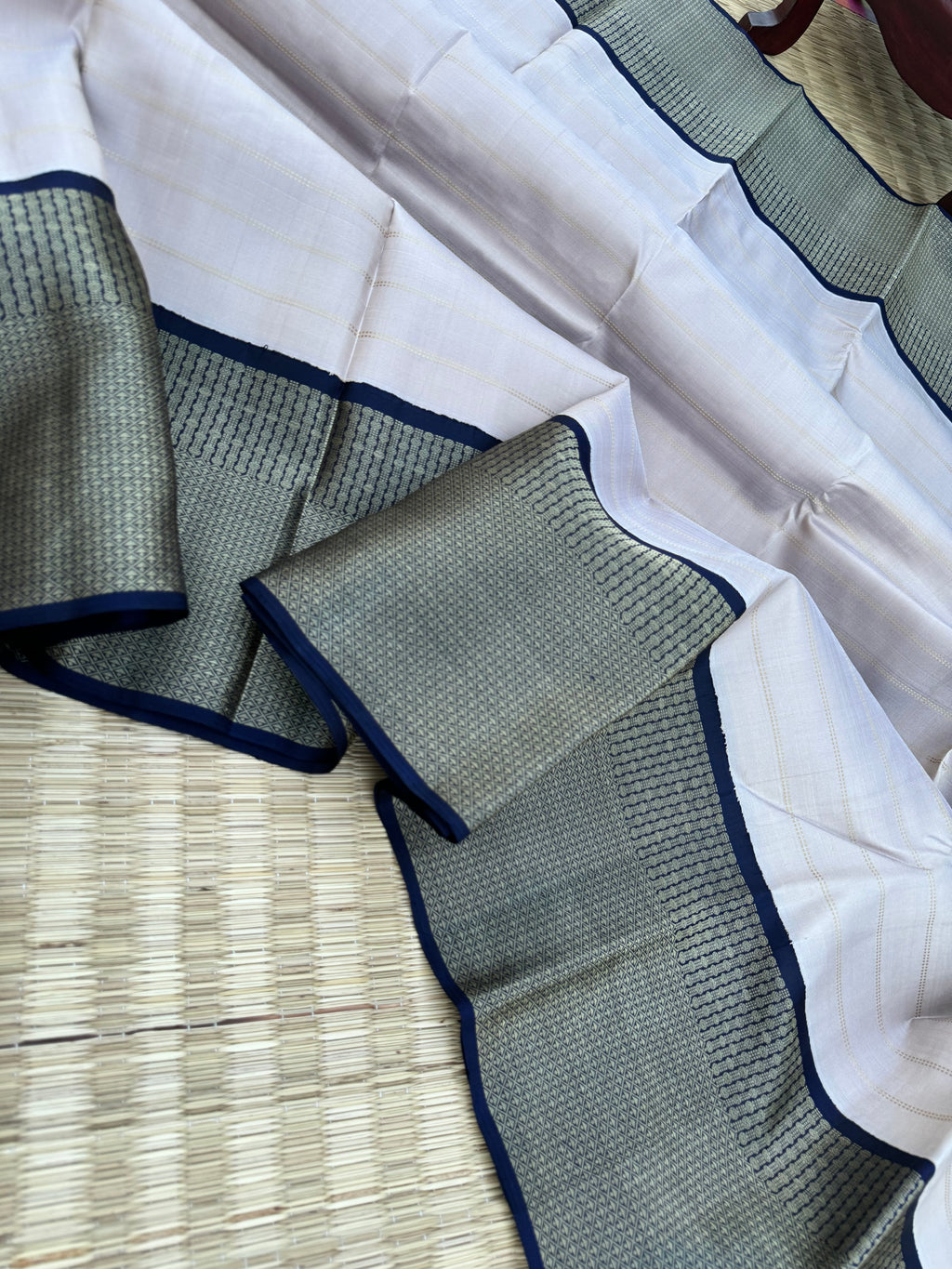 Pastel Kanchivarams - a chalk white absolutely no zari Korvai Kanchivaram with navy blue pallu and blouse