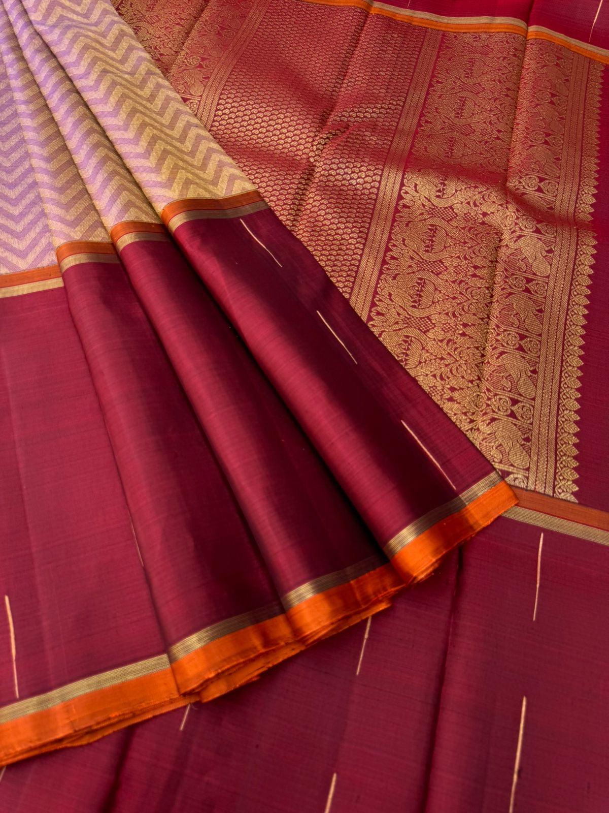 Tasteful Tall Border Kanchivarams - stunning lavender and gold Chevron V woven body with deep red long korvai woven borders with raindrops weave