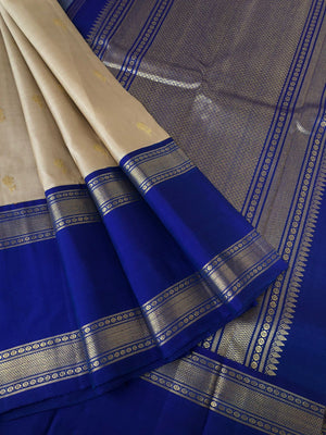 Timeless Classic Kanchivarams - the stunning beige and ink blue korvai Kanchivaram with jasmine flower woven body buttas