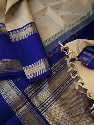 Timeless Classic Kanchivarams - the stunning beige and ink blue korvai Kanchivaram with jasmine flower woven body buttas