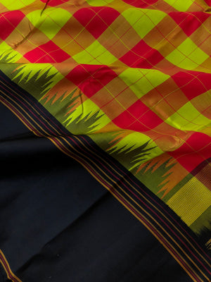 Korvai Connection on Kanchivaram - the traditional elements of red and green chex woven body with black no zari korvai woven borders and pallu