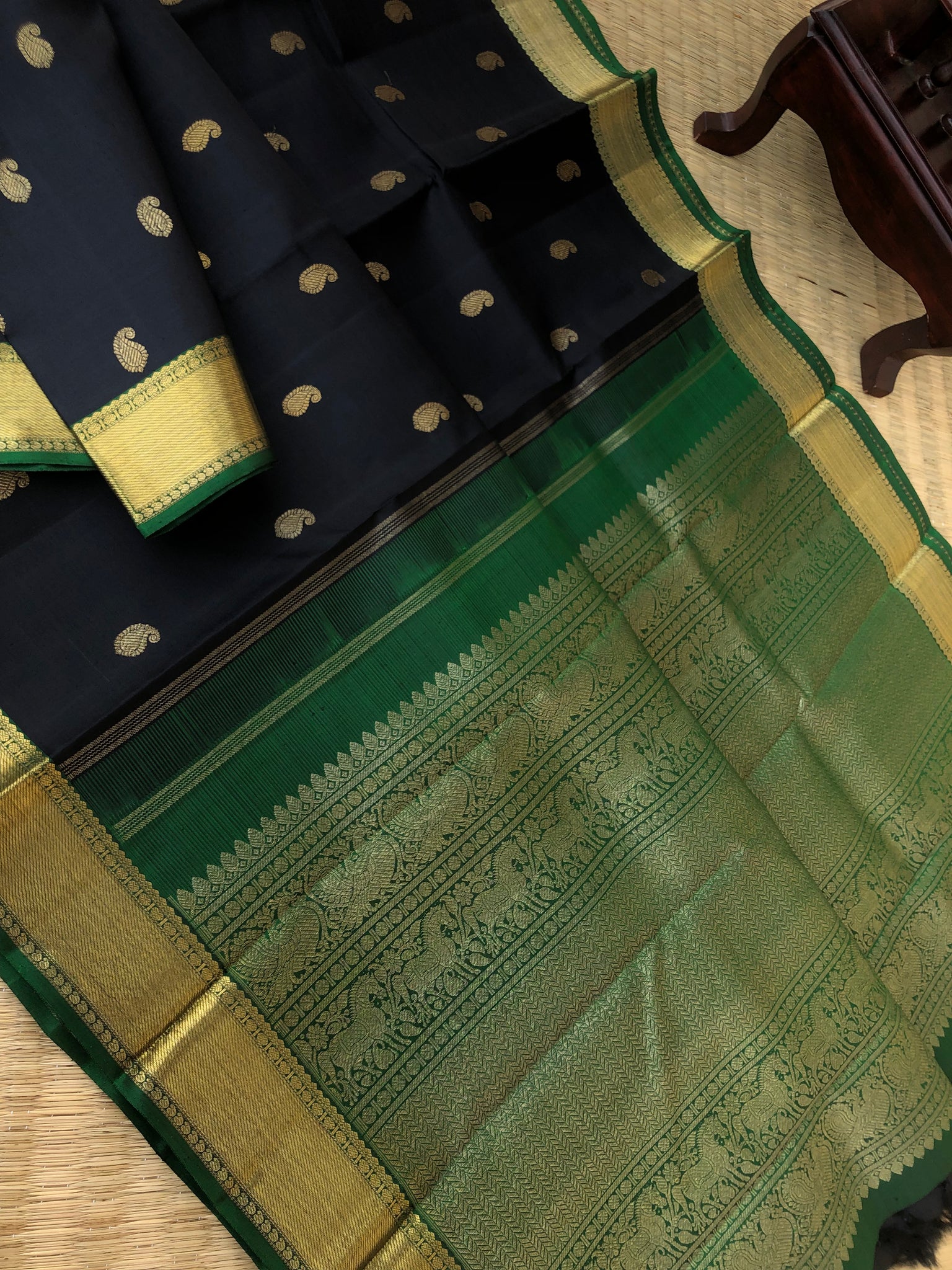 Solid Kanchivarams - stunning black and Meenakshi green solid gold Kanchivaram with paisley woven buttas is most beautiful