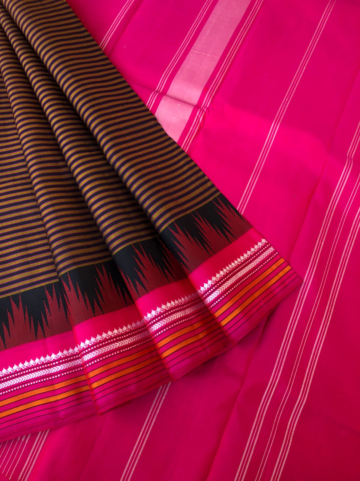 Korvai Connection on Kanchivaram - rust and black oosi vaalapoo stripes woven body with Indian pink borders pallu and blouse