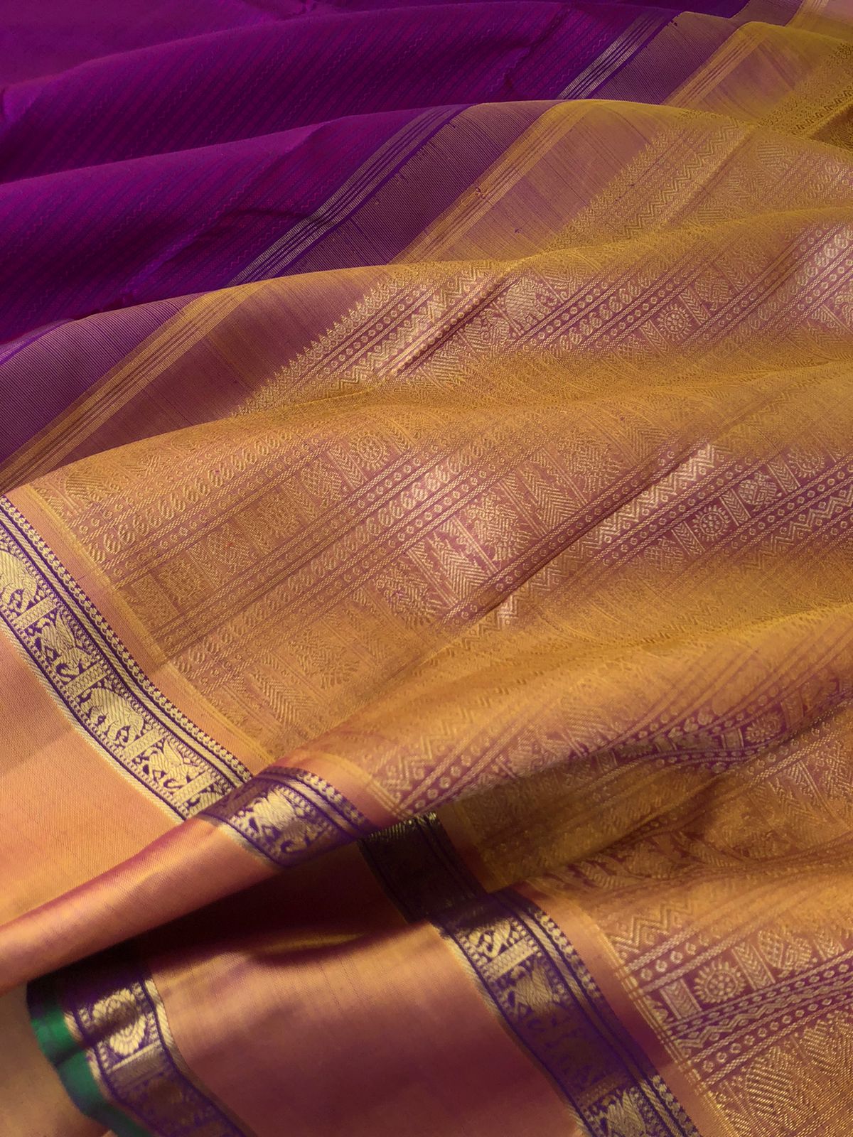 Yarn play on Kanchivaram - the deep purple pink full body vertical veldhari with retta pett woven borders and gorgeous grand gold zari woven pallu