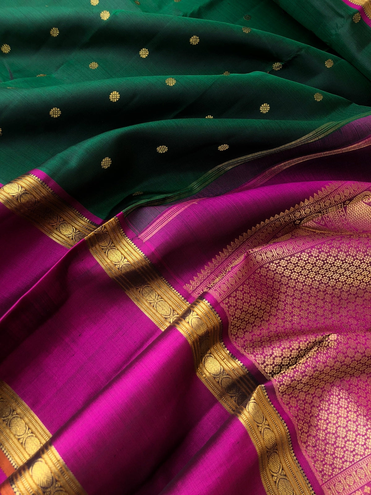 Swarnam - The lineage of Kanchivaram - stunning deep Meenakshi green and majenta pink traditional broad retta pett borders Kanchivaram with intricate buttas woven body