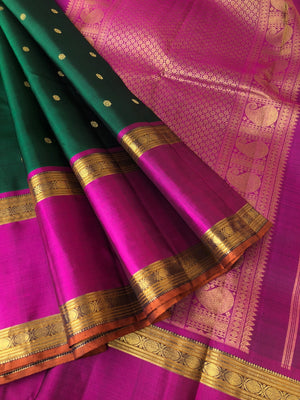 Swarnam - The lineage of Kanchivaram - stunning deep Meenakshi green and majenta pink traditional broad retta pett borders Kanchivaram with intricate buttas woven body