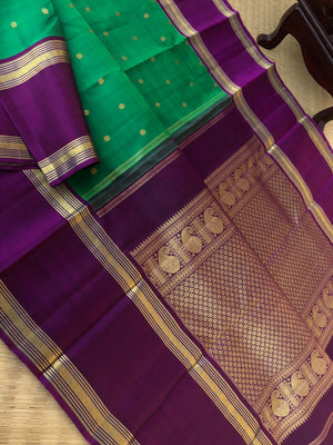 Shree - Bliss of Kanchivarams - gorgeous emerald green with deep jammun purple retta pett rudurakasham woven borders