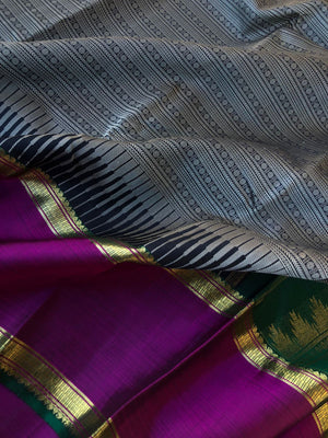 Yarn play on Kanchivaram - black and grey varusai pett with oosi gopuram borders contrasting green pallu and blouse
