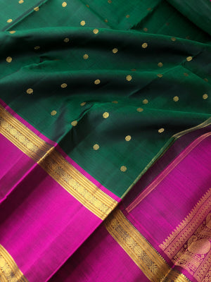 Swarnam - The lineage of Kanchivaram - stunning deep Meenakshi green and majenta pink traditional broad retta pett borders Kanchivaram with intricate buttas woven body