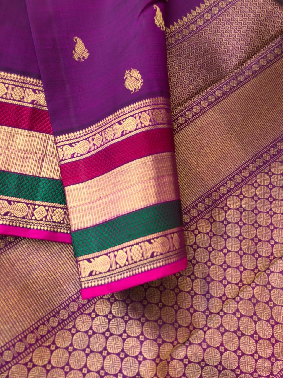The Golden Treasures Of Kanchivaram - beautiful purple gold zari woven Kanchivaram with fish meen motifs woven retta pett woven borders with silk thread highlighted in the borders in between