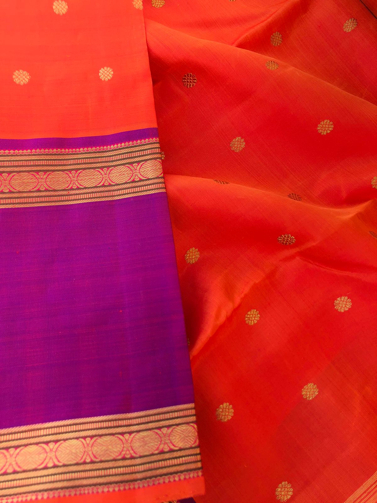 Kamakshi- Traditional Kanchivarams - the best of orange and purple broad borders Kanchivaram with stunning gold zari woven pallu