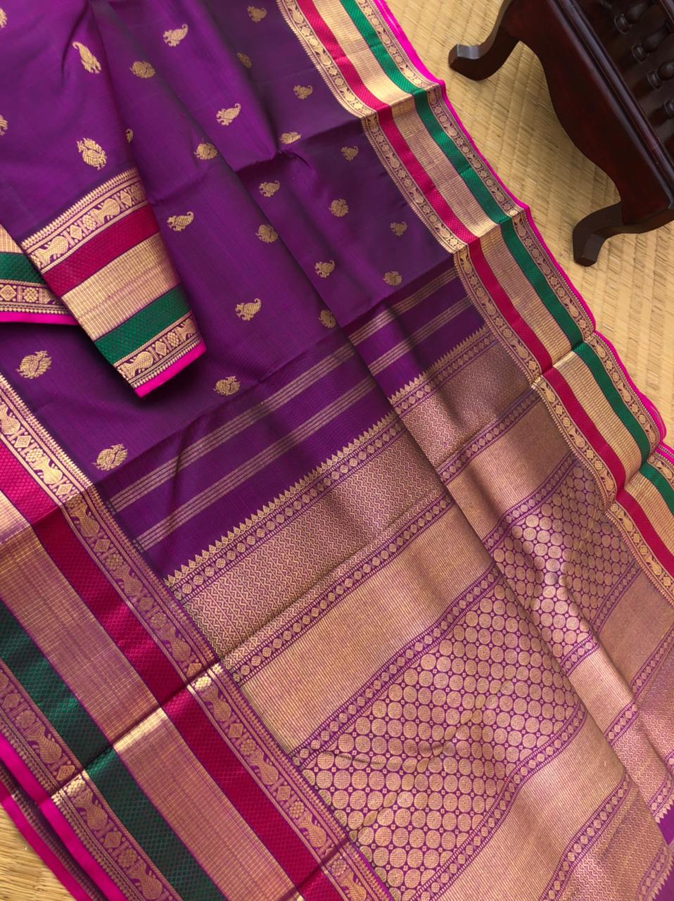 The Golden Treasures Of Kanchivaram - beautiful purple gold zari woven Kanchivaram with fish meen motifs woven retta pett woven borders with silk thread highlighted in the borders in between