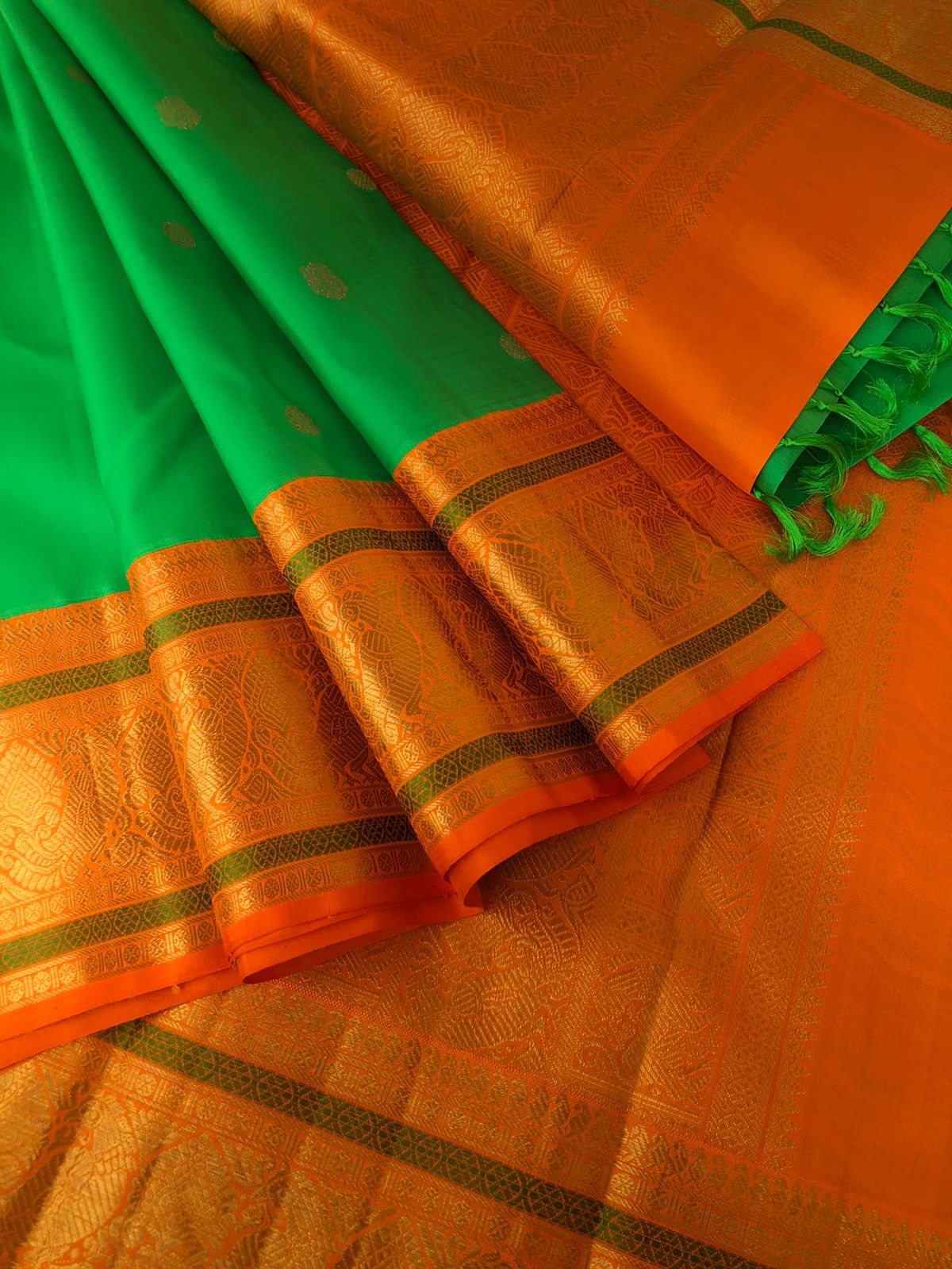 Festive Edits on Kanchivaram - the classy beauty of parrot green and orange kai korvai Kanchivaram with pakshi motifs woven borders