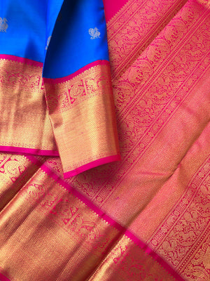 The Golden Treasure Of Kanchivaram - deeper anandha blue and rani pink with Mayil chackaram woven buttas all over the body, you can feel the gold in borders and pallu