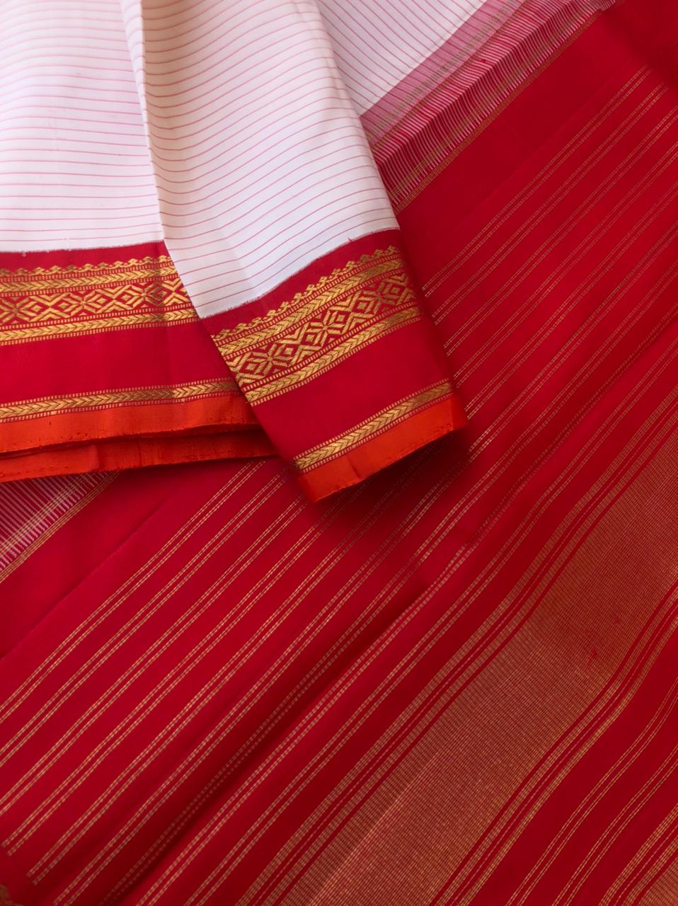 Amohaa - beautiful Korvai Kanchivarams - at the off white stripes body with red korvai woven borders with burnt orange sleeve edge all details on this saree is beautiful
