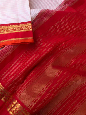 Amohaa - beautiful Korvai Kanchivarams - at the off white stripes body with red korvai woven borders with burnt orange sleeve edge all details on this saree is beautiful